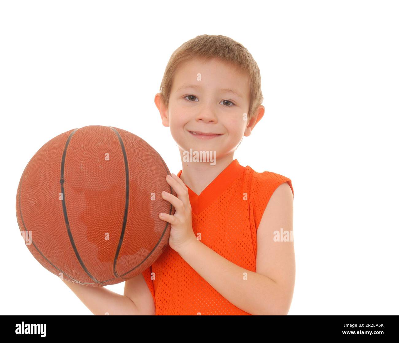 Young boy playing with a basketball isolated on white Stock Photo - Alamy