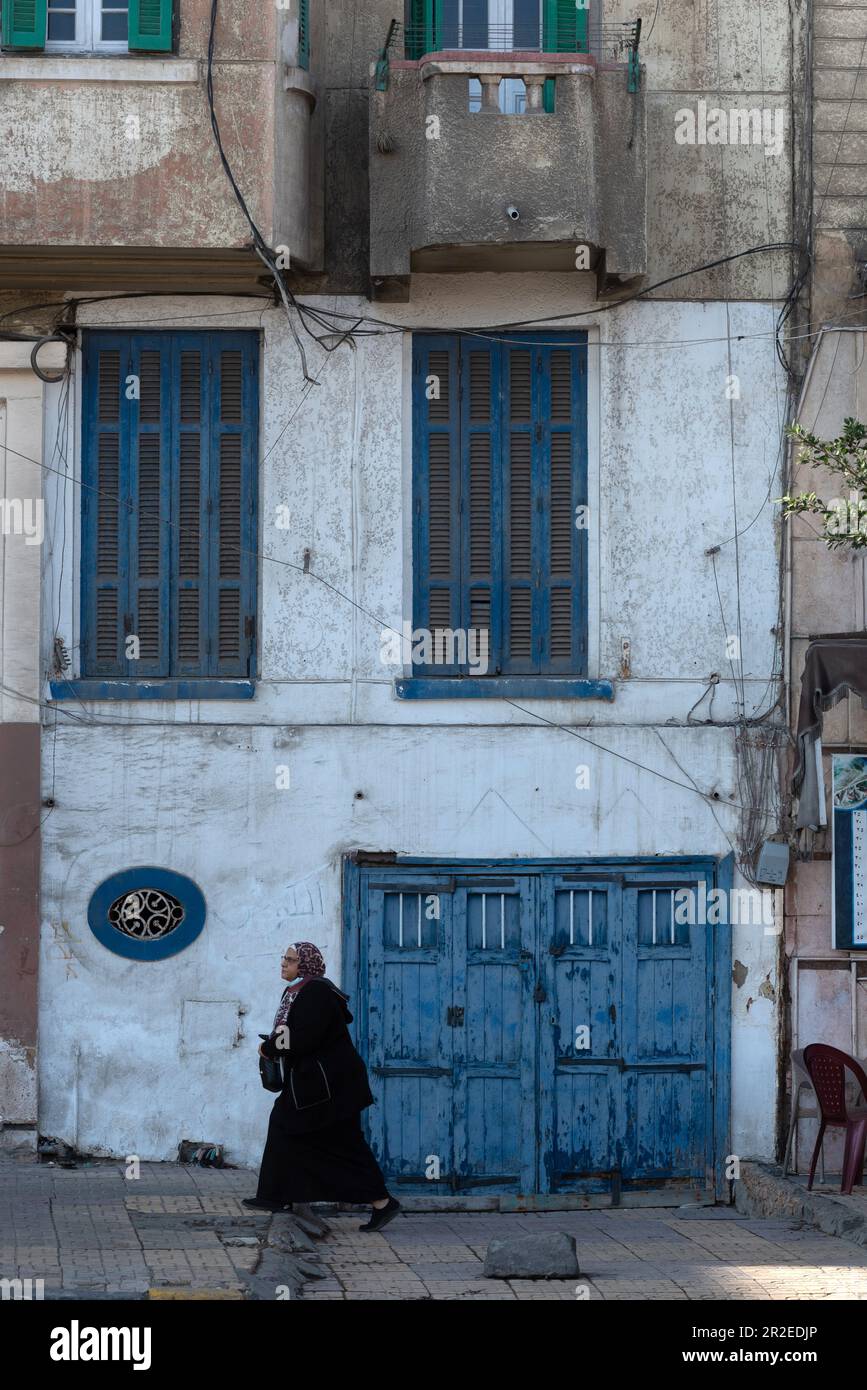Blue painted doors and windows of faded traditional architecture along the Corniche of the north Egyptian Delta city of Alexandria, Egypt. Stock Photo