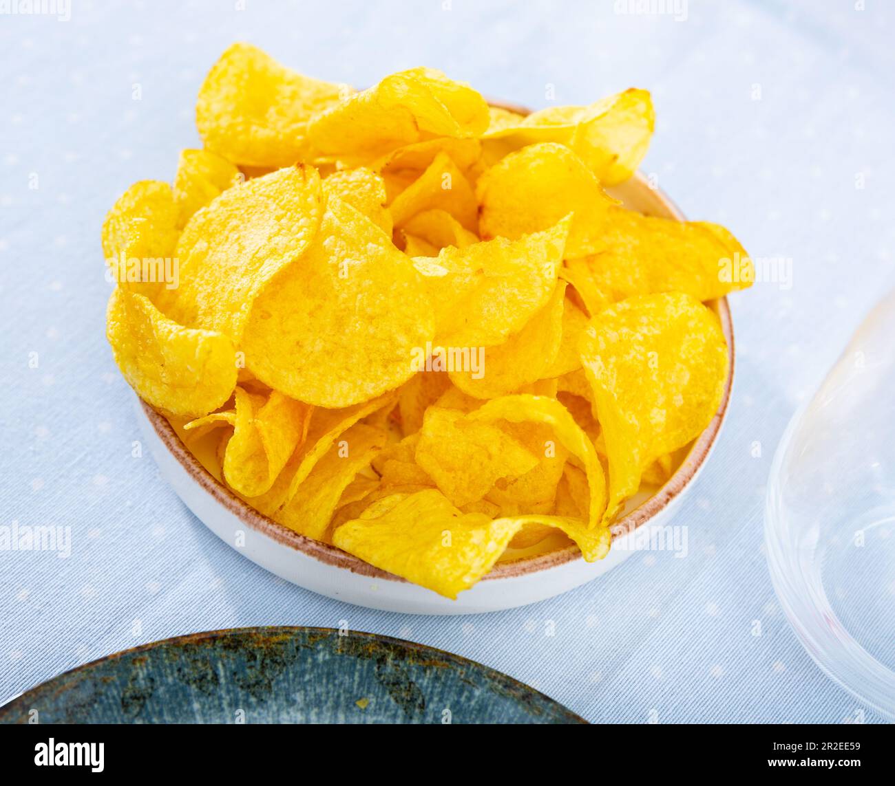 Pile of salty crunchy deep fried potato chips on plate Stock Photo Alamy