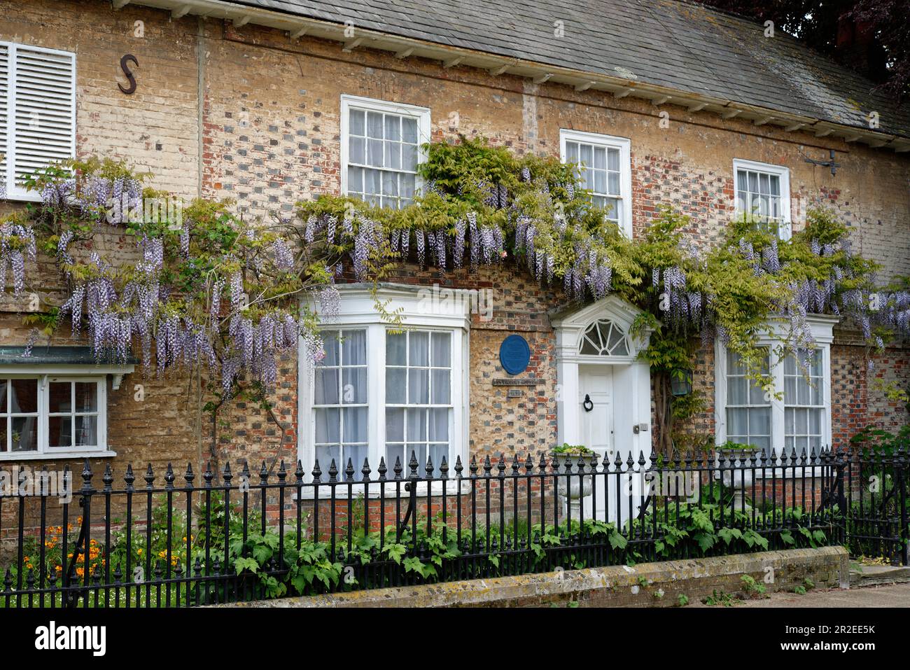 England in the Spring. Wysteria in full bloom. Houses in the village of Portchester. Pretty houses in Castle Street. Stock Photo