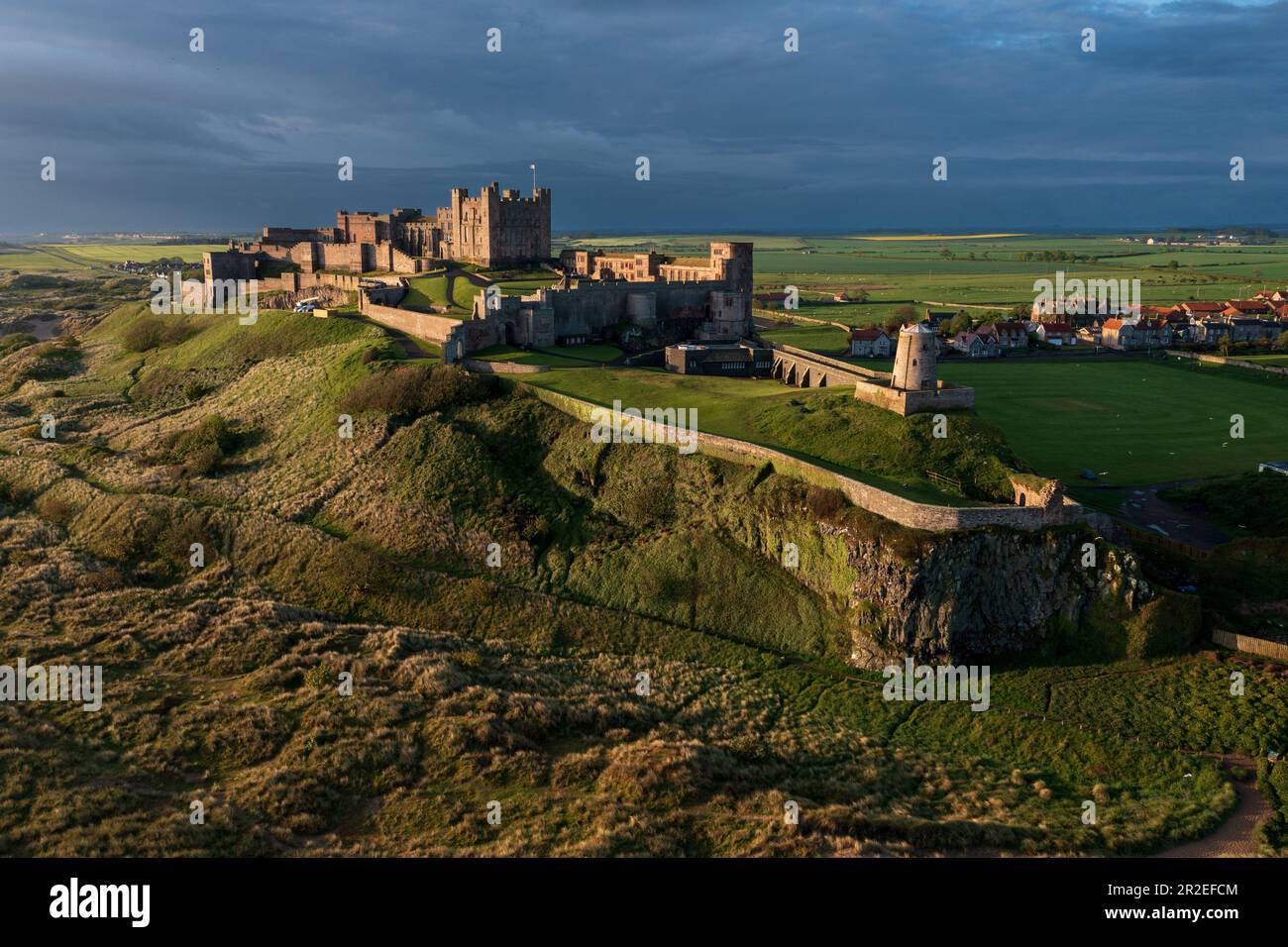 Early morning aerial view of the iconic Bamburgh Castle on the Northumberland coast. England, UK Stock Photo
