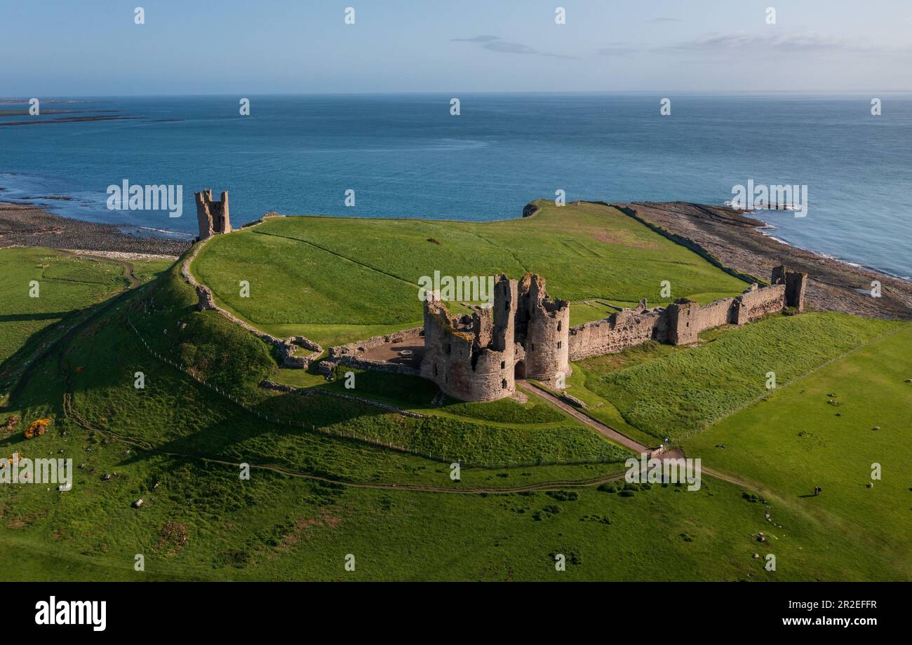 Aerial view of the ruined remains of Dunstanburgh Castle on the Northumberland coast, north east England, UK Stock Photo
