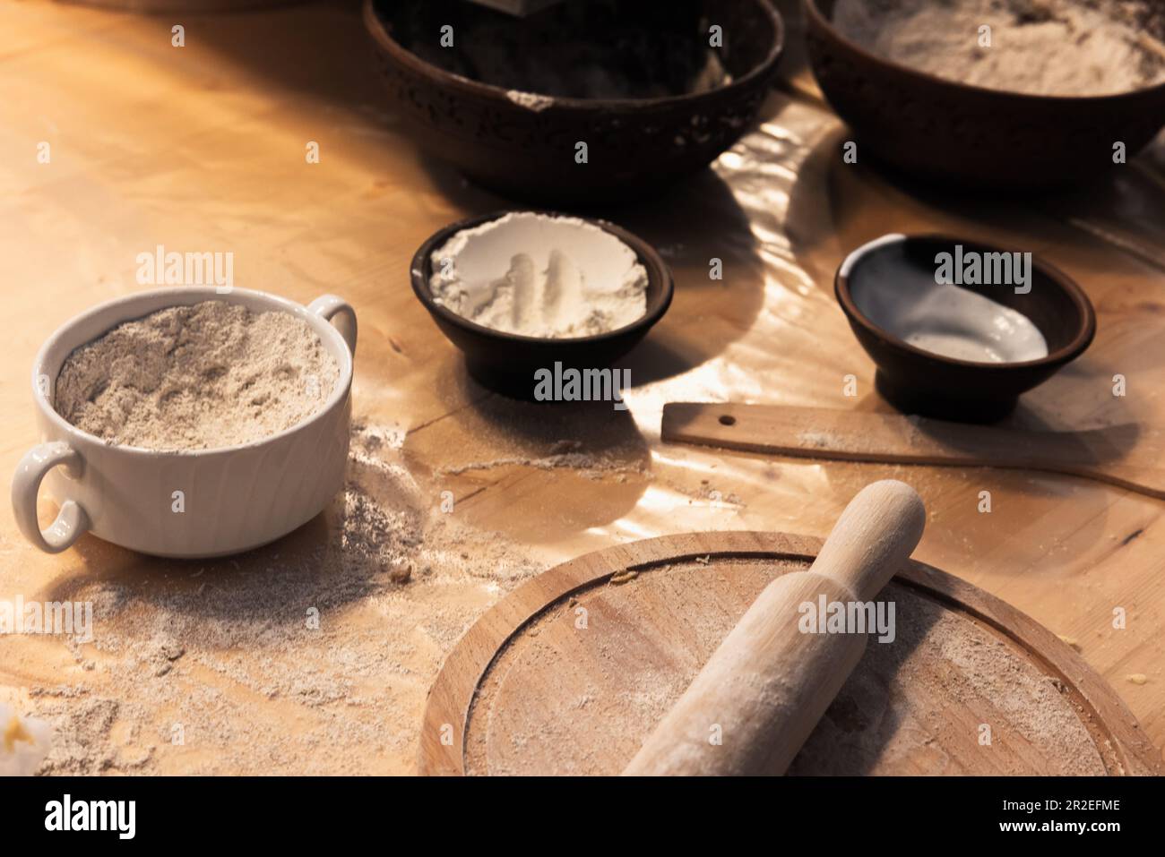 Bowls of rye and wheat flour are on a table in a bakery, close up photo Stock Photo