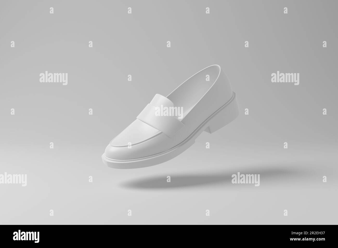 White chunky loafer floating in mid air with shadow on white background in monochrome. Illustration of the concept of footwear, menswear and fashion Stock Photo