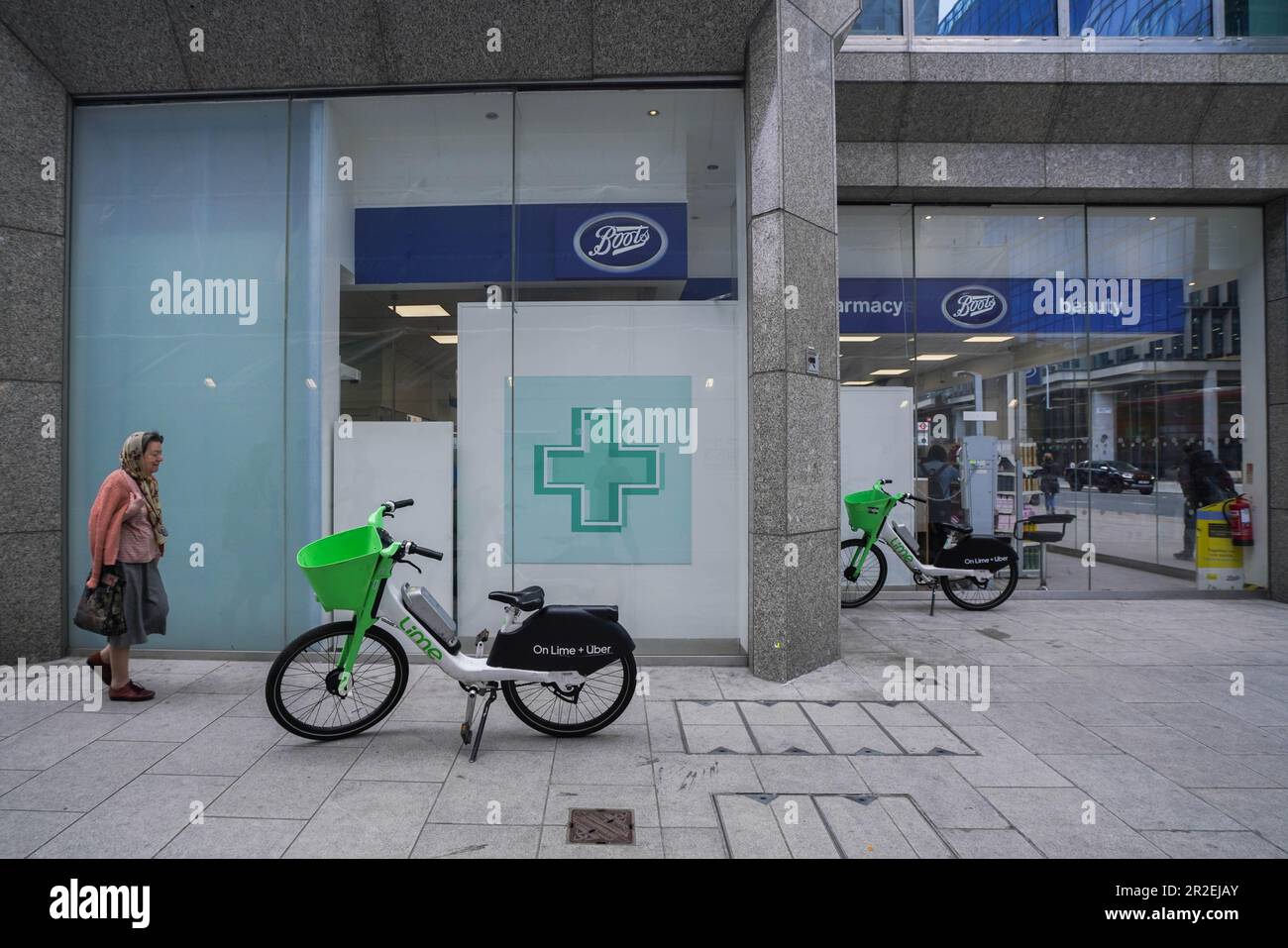 London UK. 19 May 2023 A pedestrian walk past Lime hire electric bikes