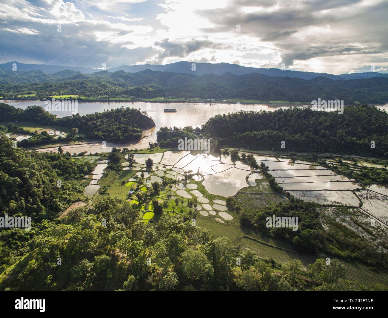 Aerial of rice fields with river cruise ship Anawrahta (Heritage Line ...