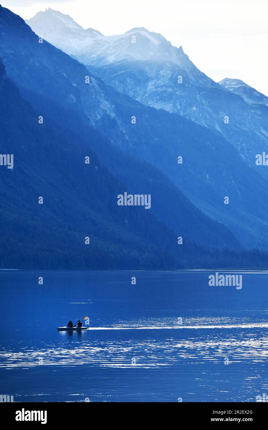 Kayakers in the sea against a mountain backdrop. Heines, Alaska, Stock Photo