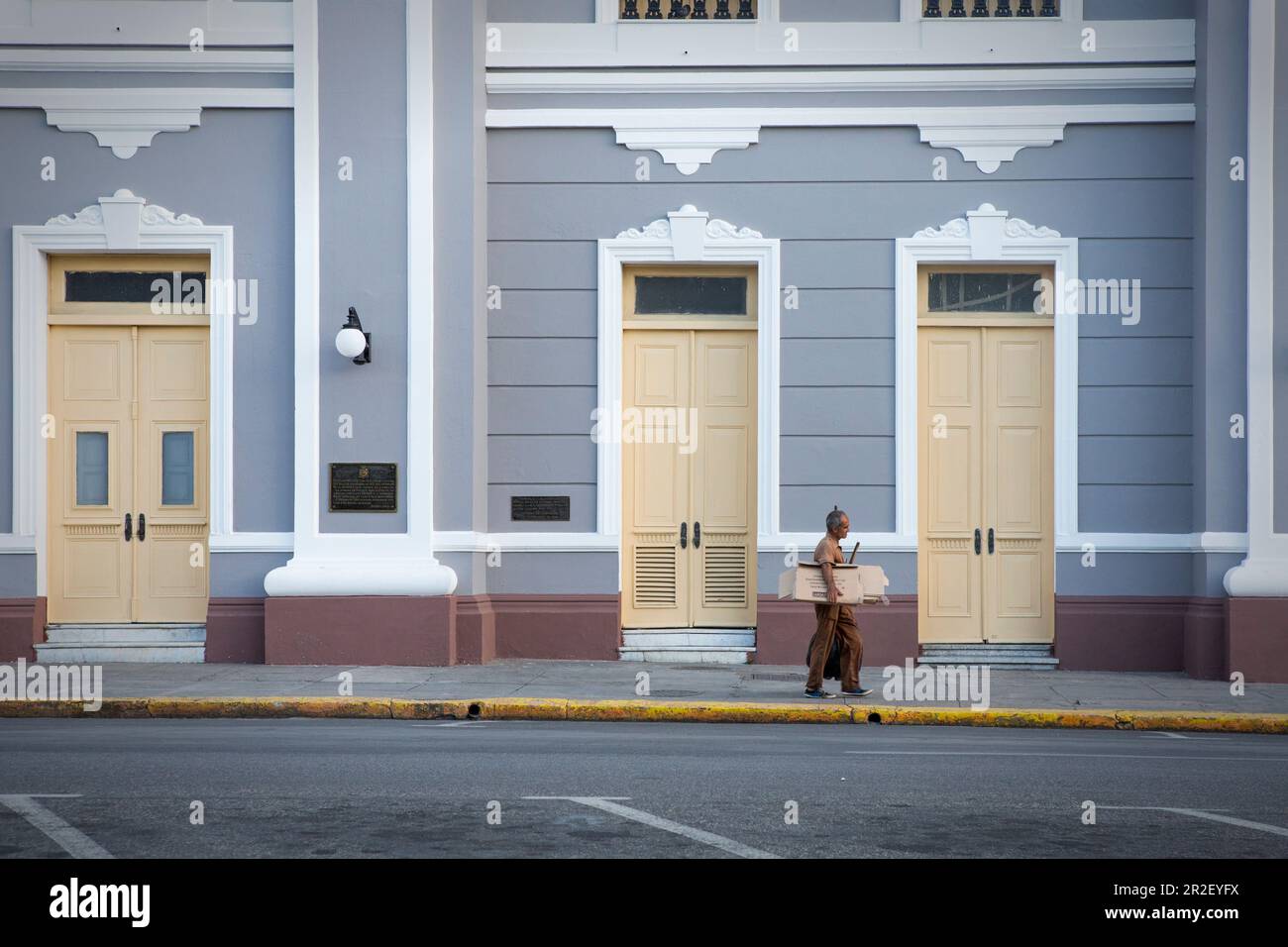 Man in front of house facade of Palacio de Gobierno in Cienfuegos, Cuba Stock Photo
