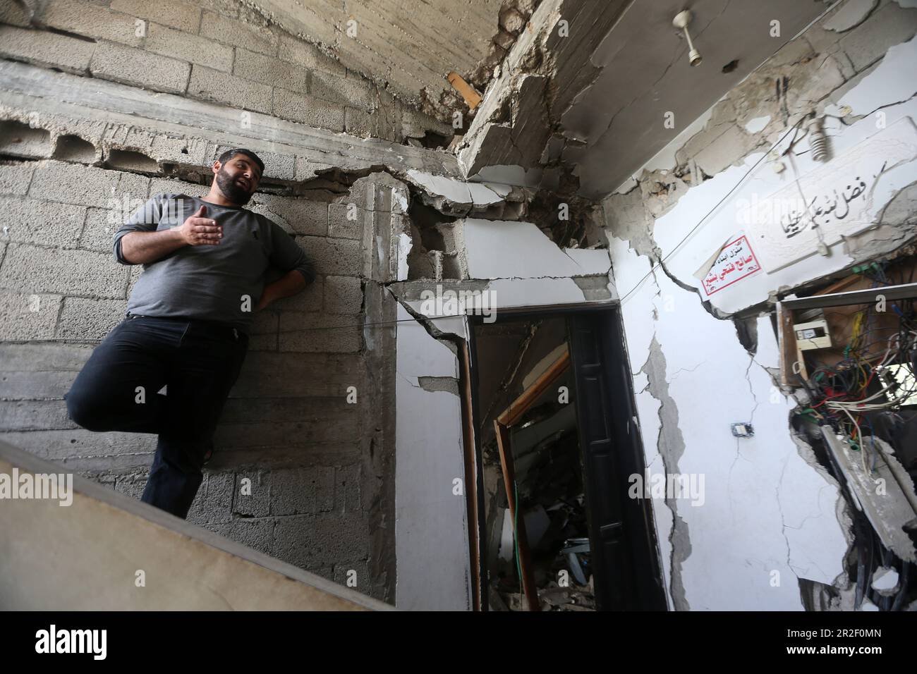 A man inspects a destroyed building belonging to the Al-Bashir Family after the Israeli attacks in Deir Balah, Gaza City. Palestine. Stock Photo