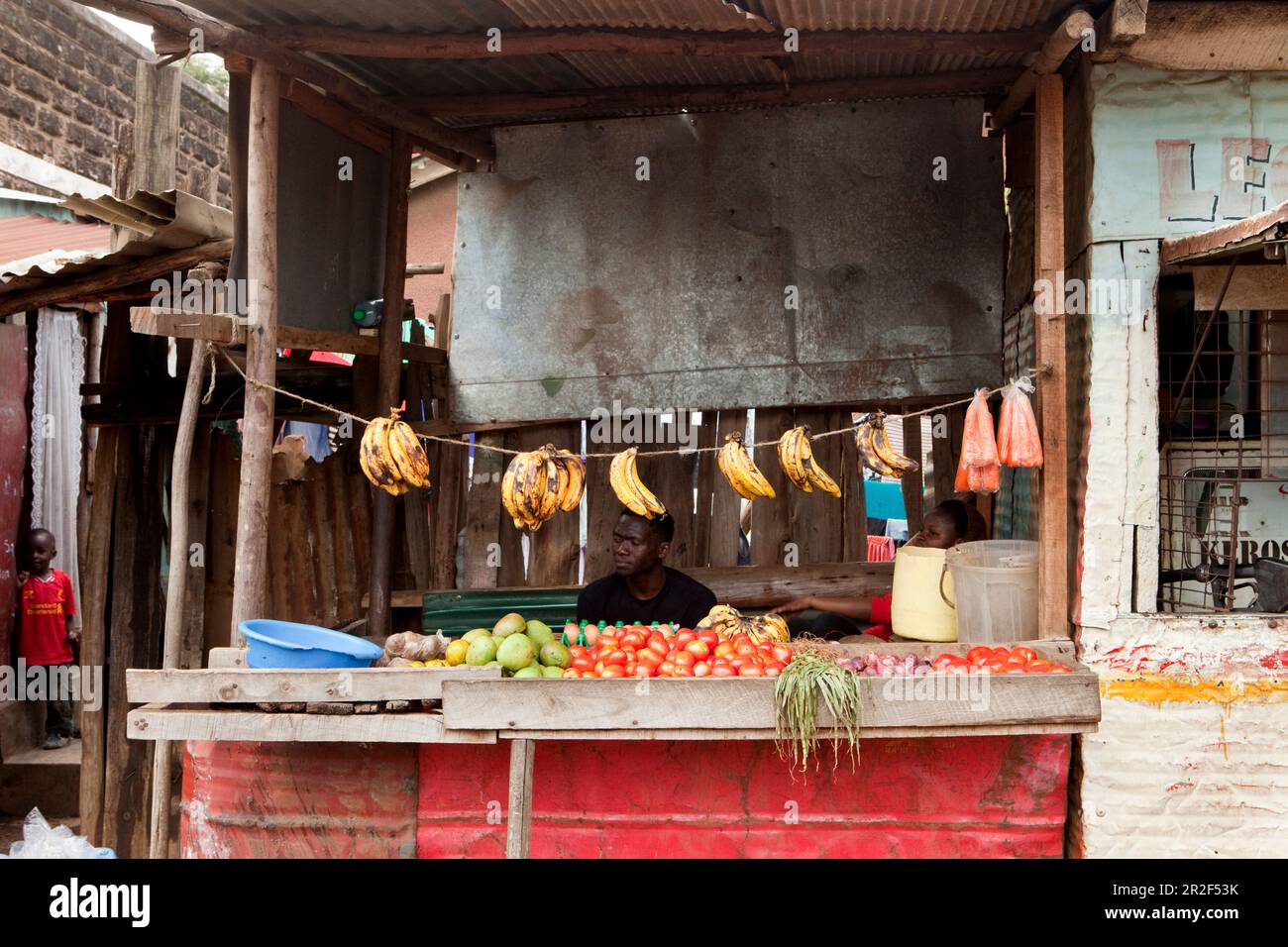 Kenyans at his fruit and vegetable stall in the slum, Eastleigh