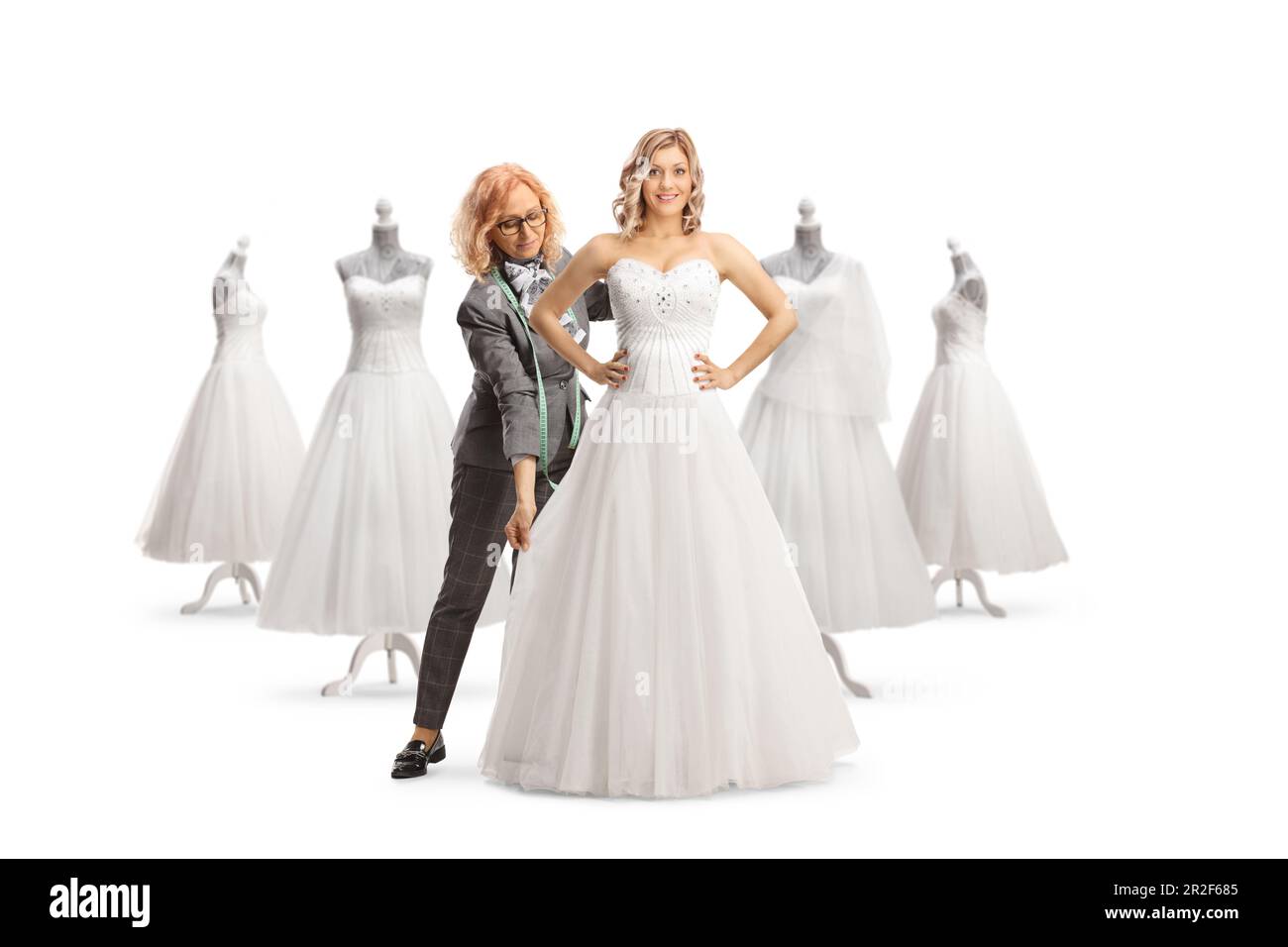 Fashion designer taking measures for a bridal dress isolated on white background isolated on white background Stock Photo