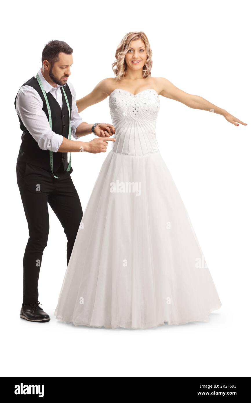 Tailor taking measures for a bridal dress isolated on white background