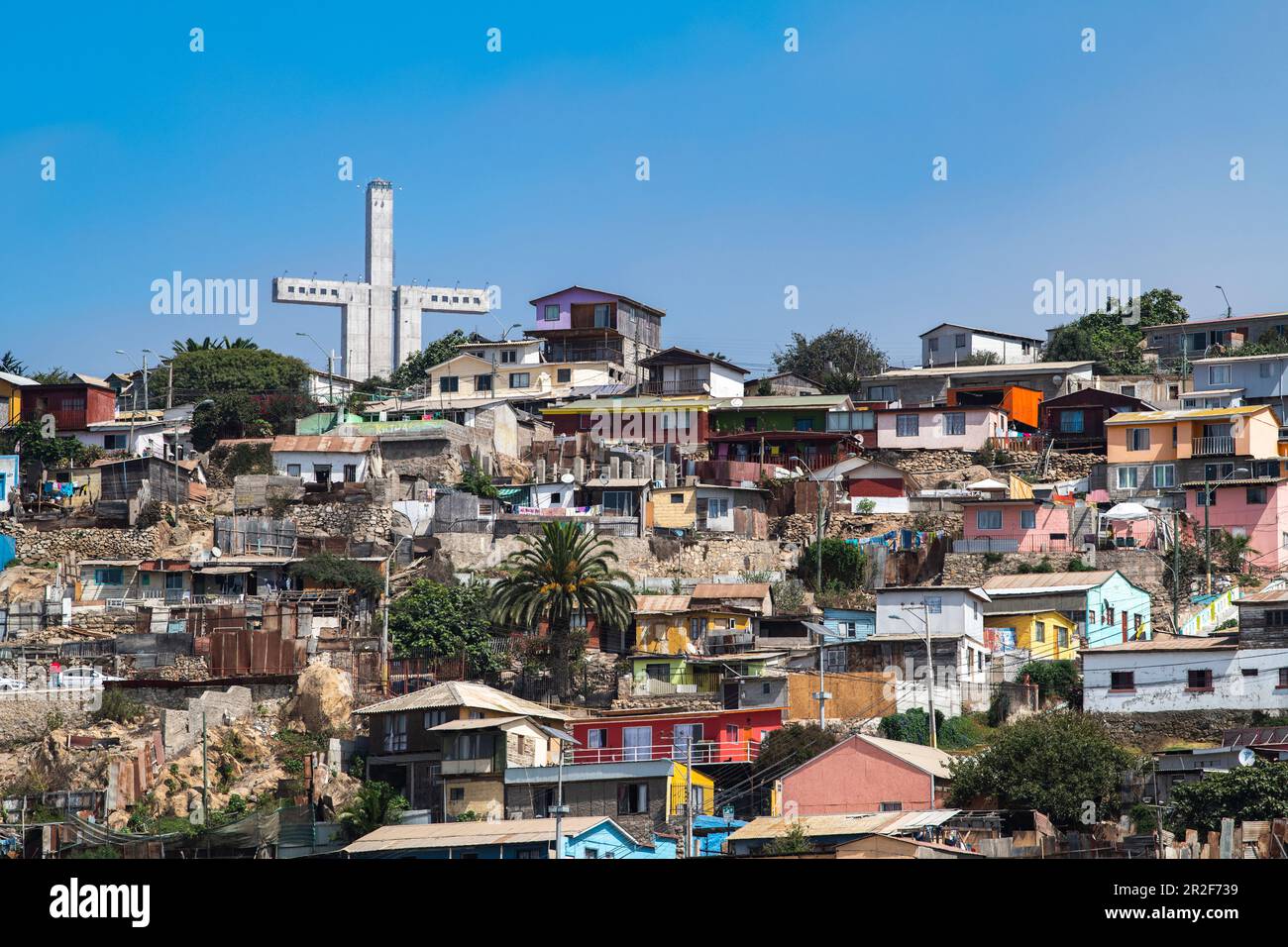 Dense, colorful houses on a slope with a monumental cross, La Serena, Coquimbo, Chile, South America Stock Photo