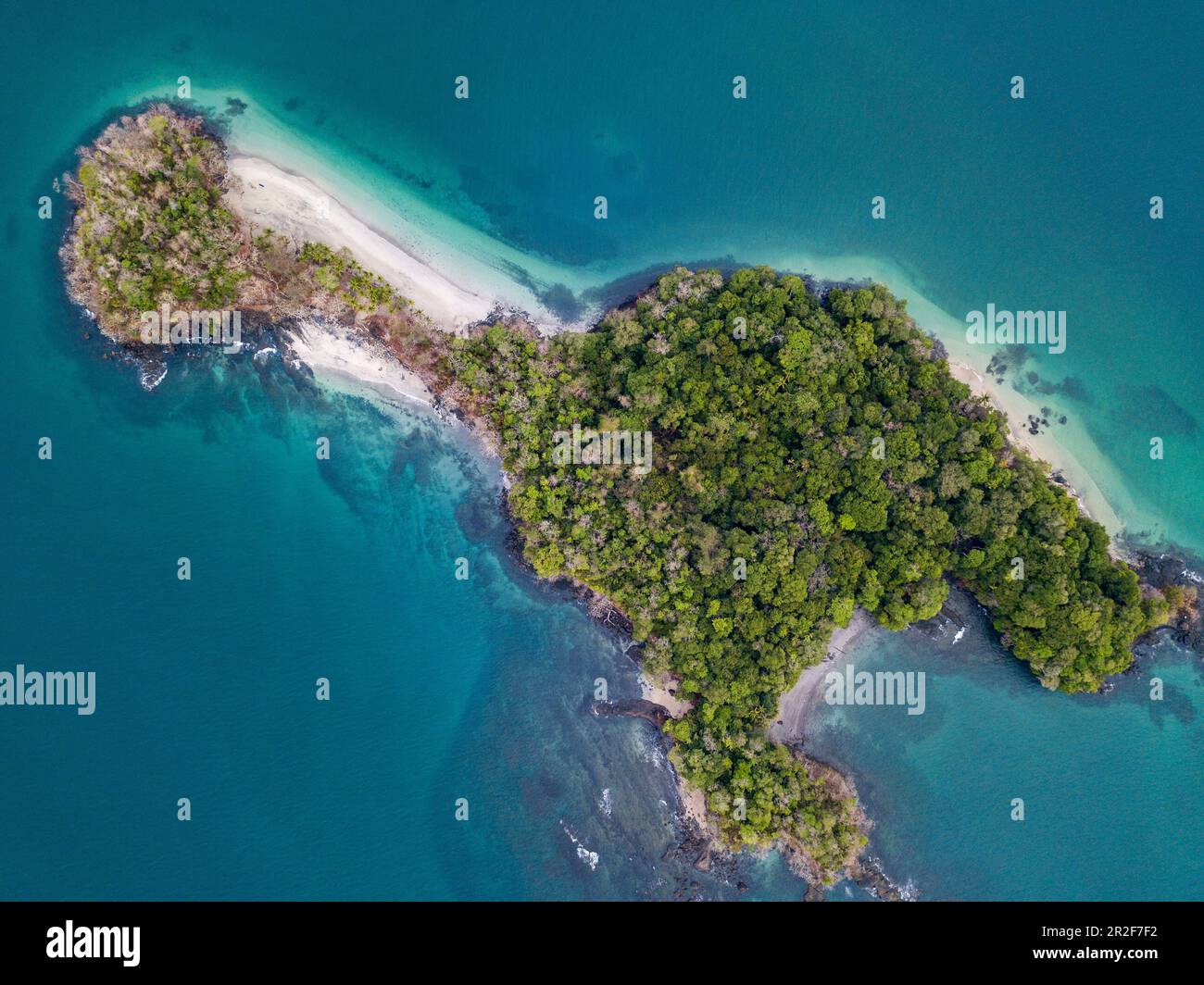 Aerial view of the lush, green island surrounded by water in various