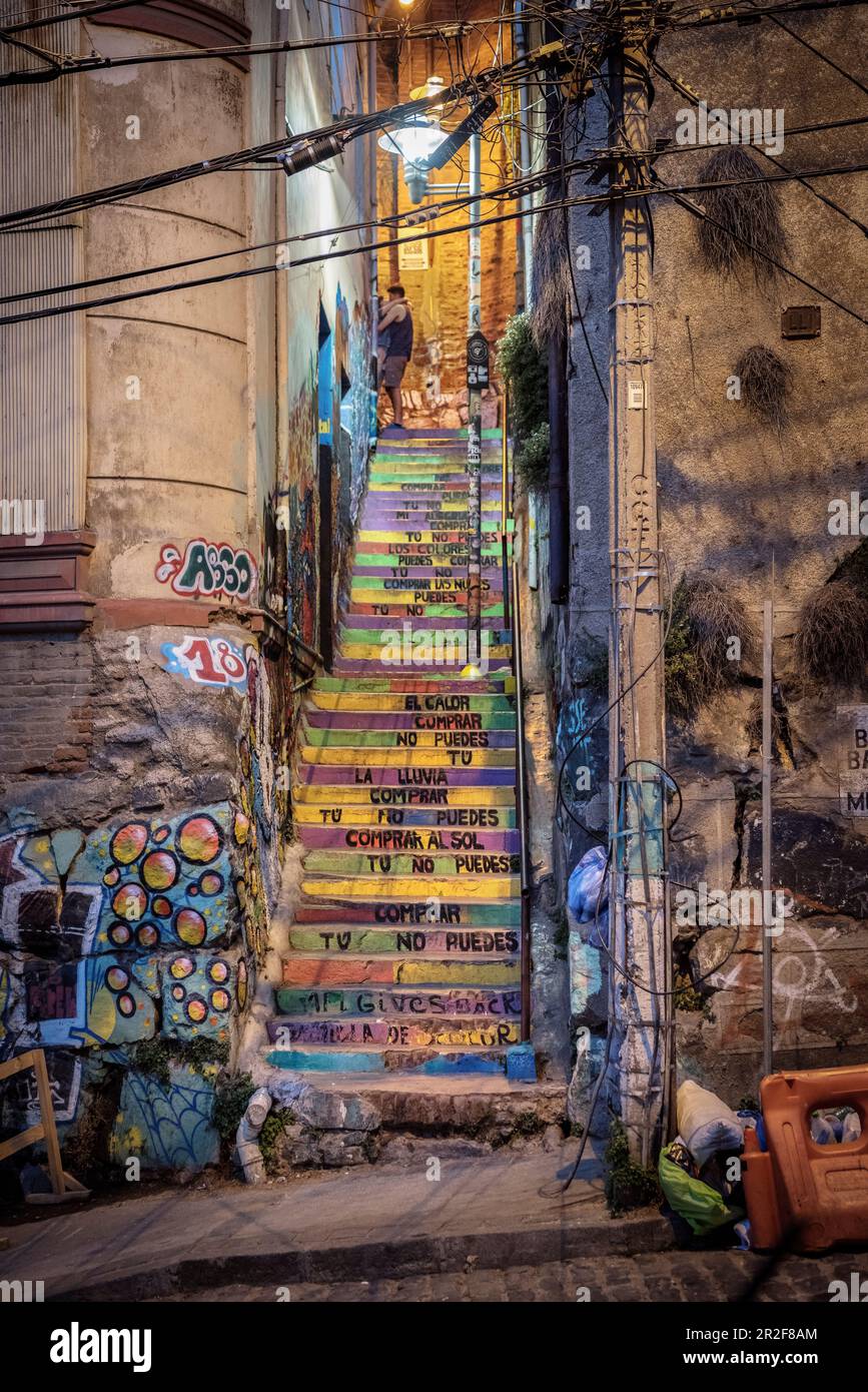 colorful stairs, young loving couple, street art in the streets of Valparaiso, Chile, South America Stock Photo