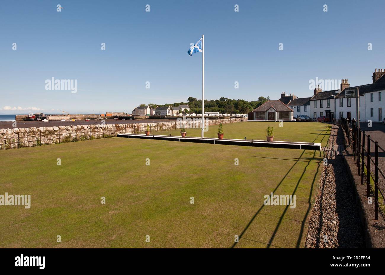 A St Andrews flag flies on Garlieston lawn bowling green beside the sea in Dumfries and Galloway Scotland Stock Photo