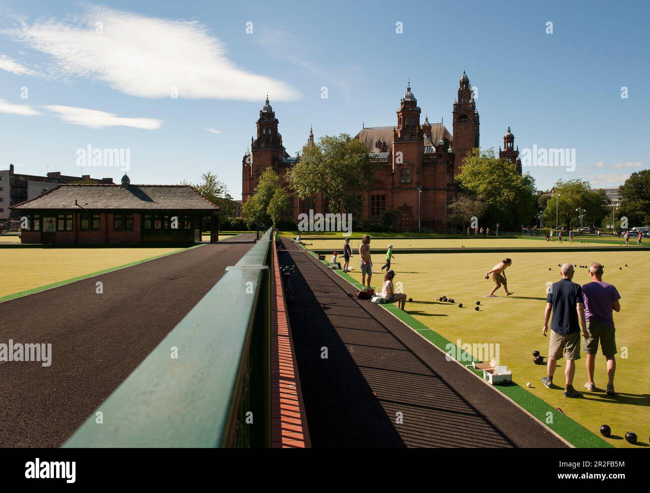 Bowls in play at the Kelvingrove lawn bowling green in front of the Kelvingrove Art Gallery and Museum on a hot day in Glasgow, Scotland, UK Stock Photo