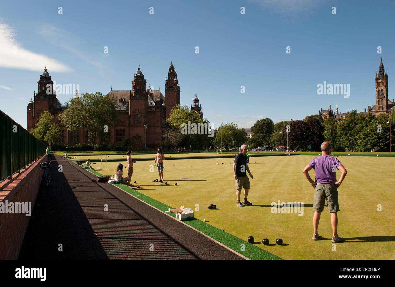 Bowls in play at the Kelvingrove lawn bowling green in front of the Kelvingrove Art Gallery and Museum on a hot day in Glasgow, Scotland, UK Stock Photo