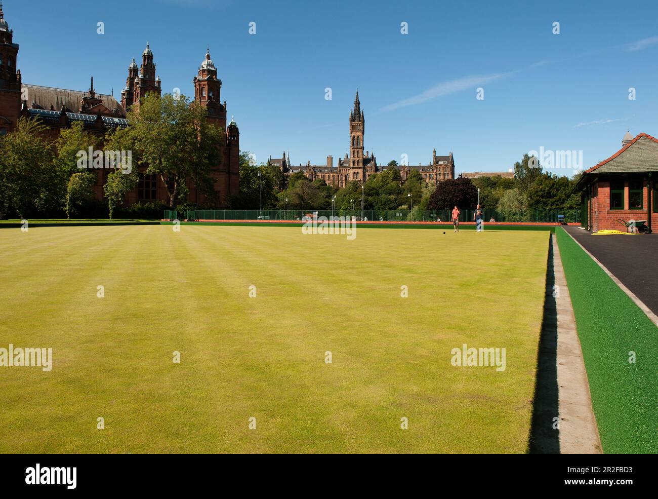 Bowls in play at the Kelvingrove lawn bowling green in front of the Kelvingrove Art Gallery and Museum and the University of Glasgow in Glasgow, Scotl Stock Photo