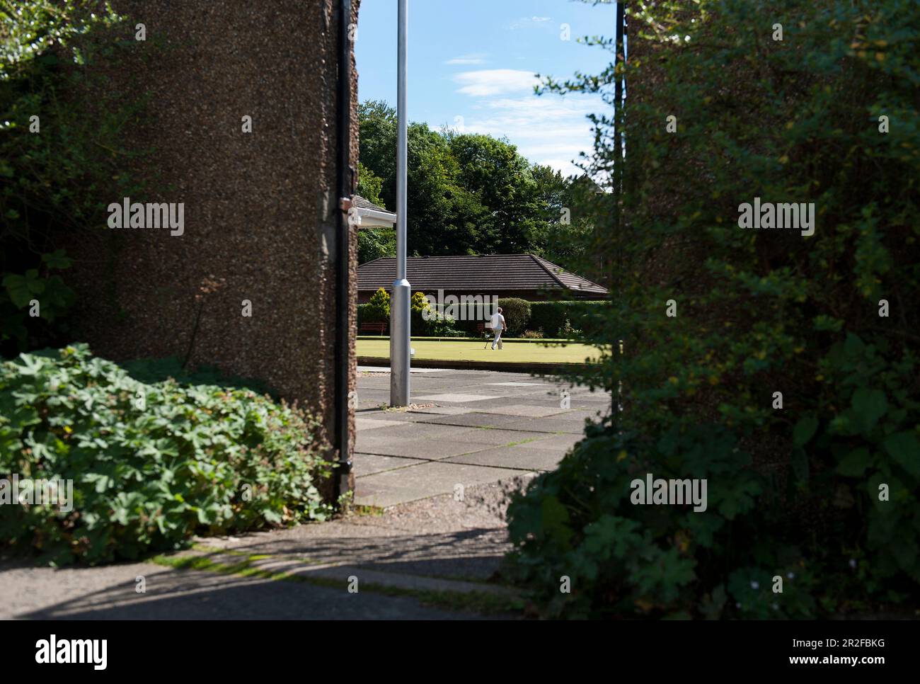 A view of bowls in play through an entrance to the Kilmarnock lawn bowling green in Kilmarnock, Ayrshire, Scotland, UK Stock Photo
