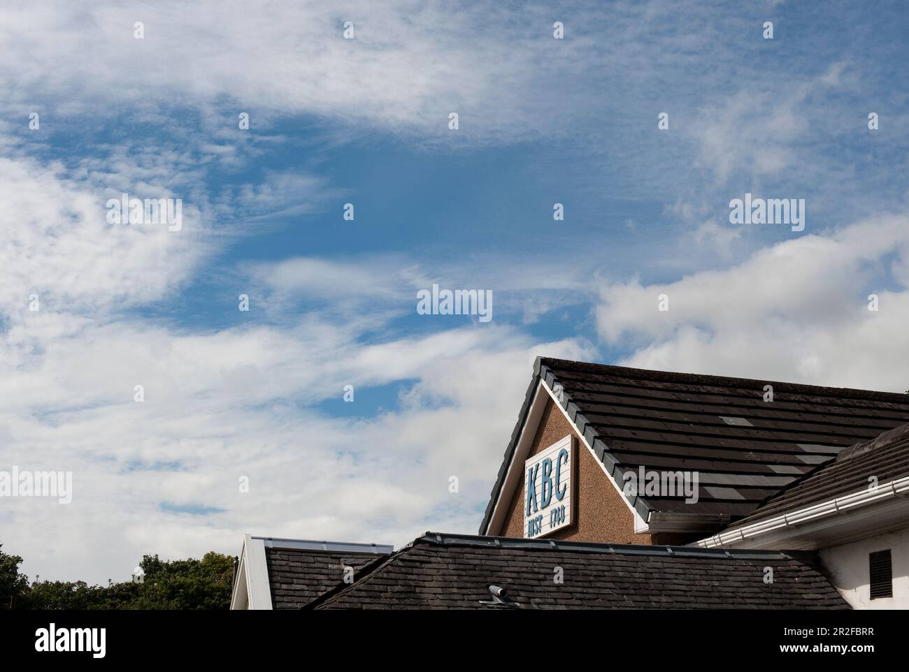 The large KBC INST 1740 sign at the top of the pavilion of the Kilmarnock lawn bowling green in