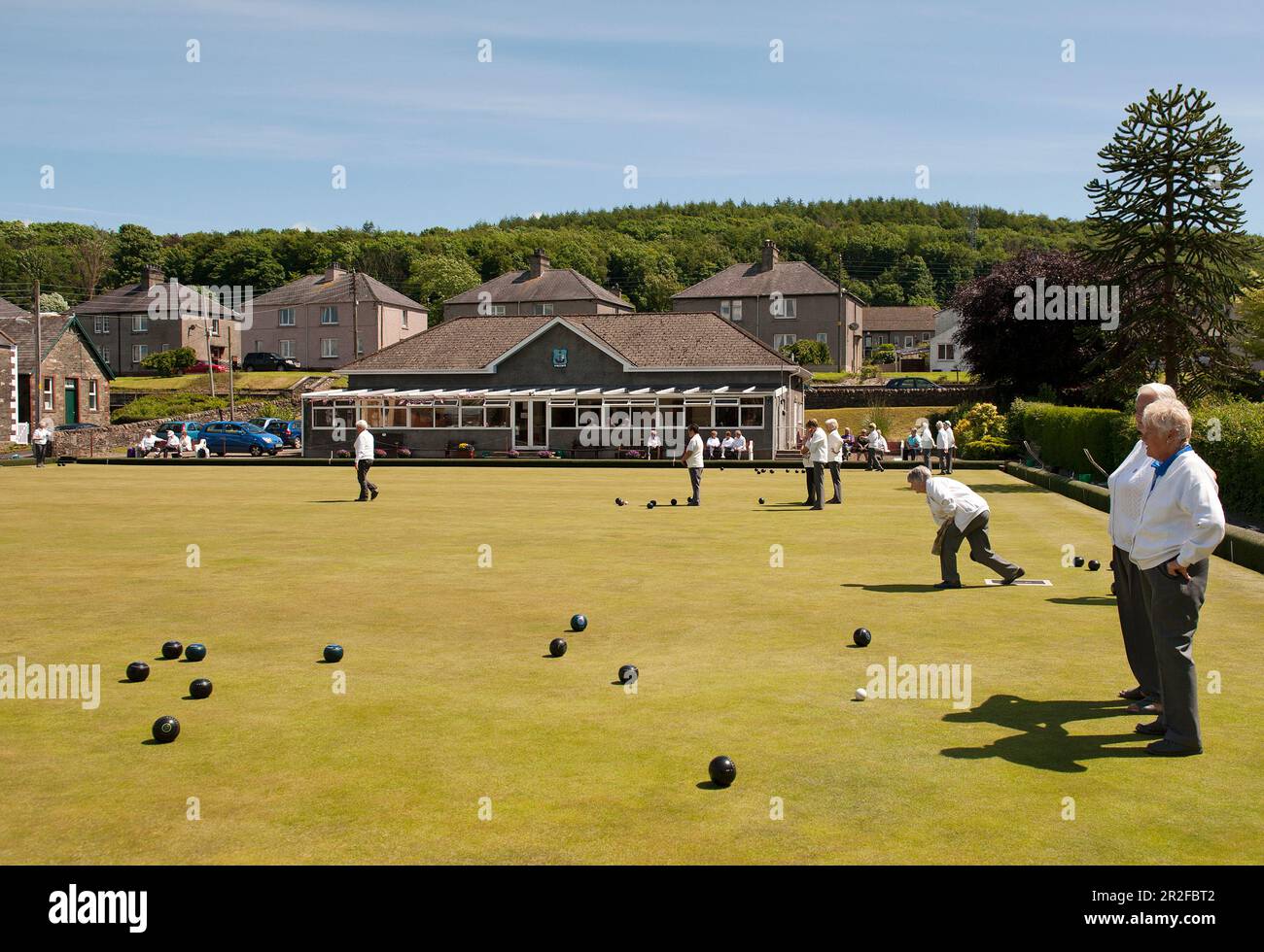 Bowls in play in front of the pavilion of the Kirkcudbright lawn bowling green in Dumfries and Galloway, Scotland, UK Stock Photo