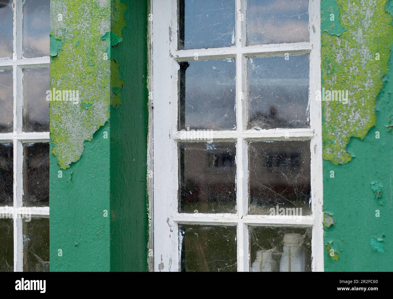 Peeling paint beside the windows of the pavilion club house at the Mauchline lawn bowling green in Mauchline; Ayrshire, Scotland, UK Stock Photo