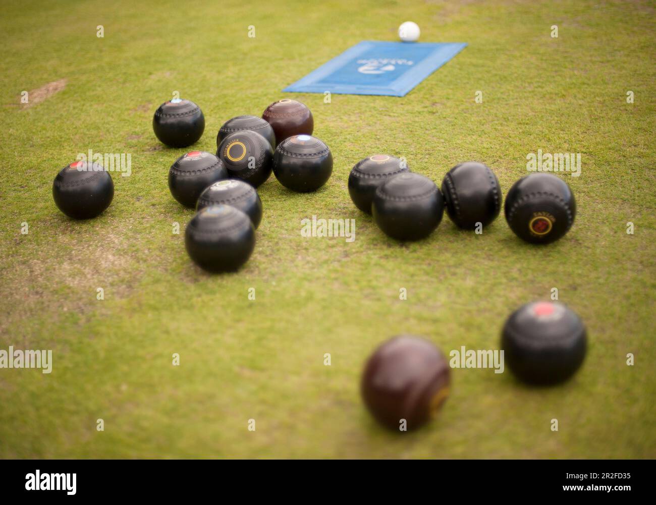 Bowling balls jack and mat on a lawn green at the Mauchline lawn bowling green in Mauchline; Ayrshire, Scotland, UK Stock Photo