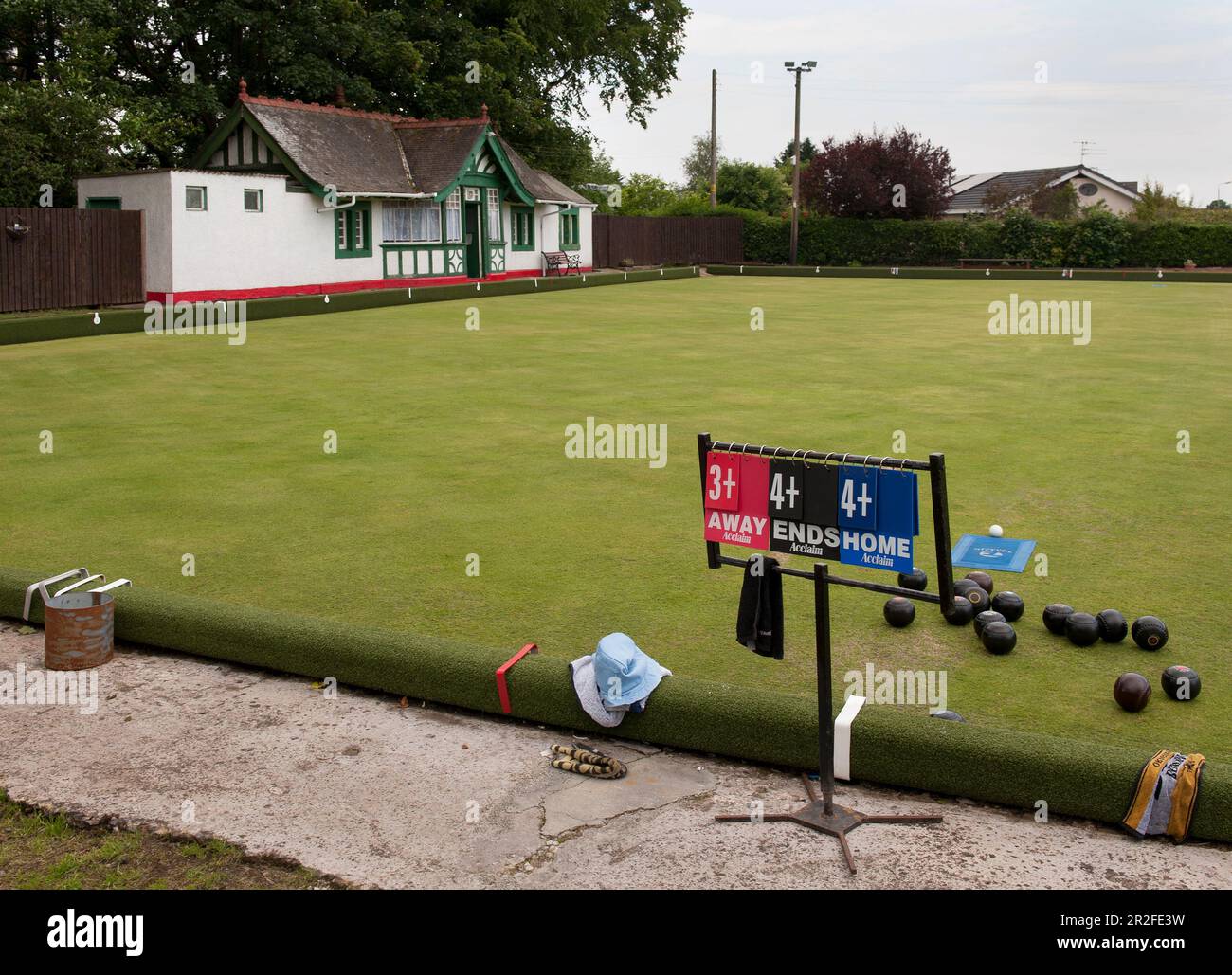 The score card and bowling balls, jack and mat on the Mauchline lawn bowling green in Mauchline; Ayrshire, Scotland, UK Stock Photo
