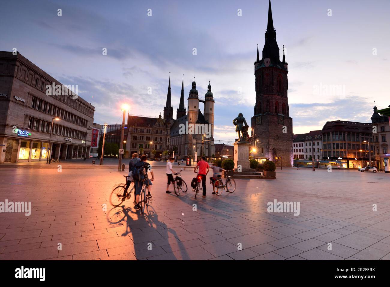 in the evening, market church with red tower on the market, cathedral, square, cyclists, tourists, Halle an der Saale, Saxony-Anhalt, Germany Stock Photo