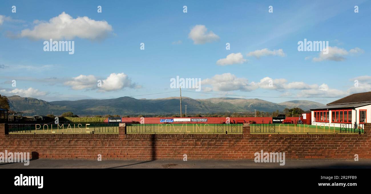 The metal fence bearing the name of the Polmaise lawn bowling club green beneath the Ochil hills in Fallin, Stirlingshire Scotland, UK Stock Photo