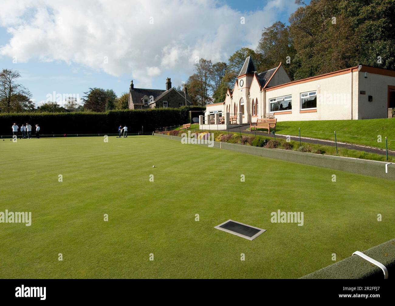 Bowls in play in front of the pavilion of the Stirling lawn bowling club green in Stirling, Scotland, UK Stock Photo