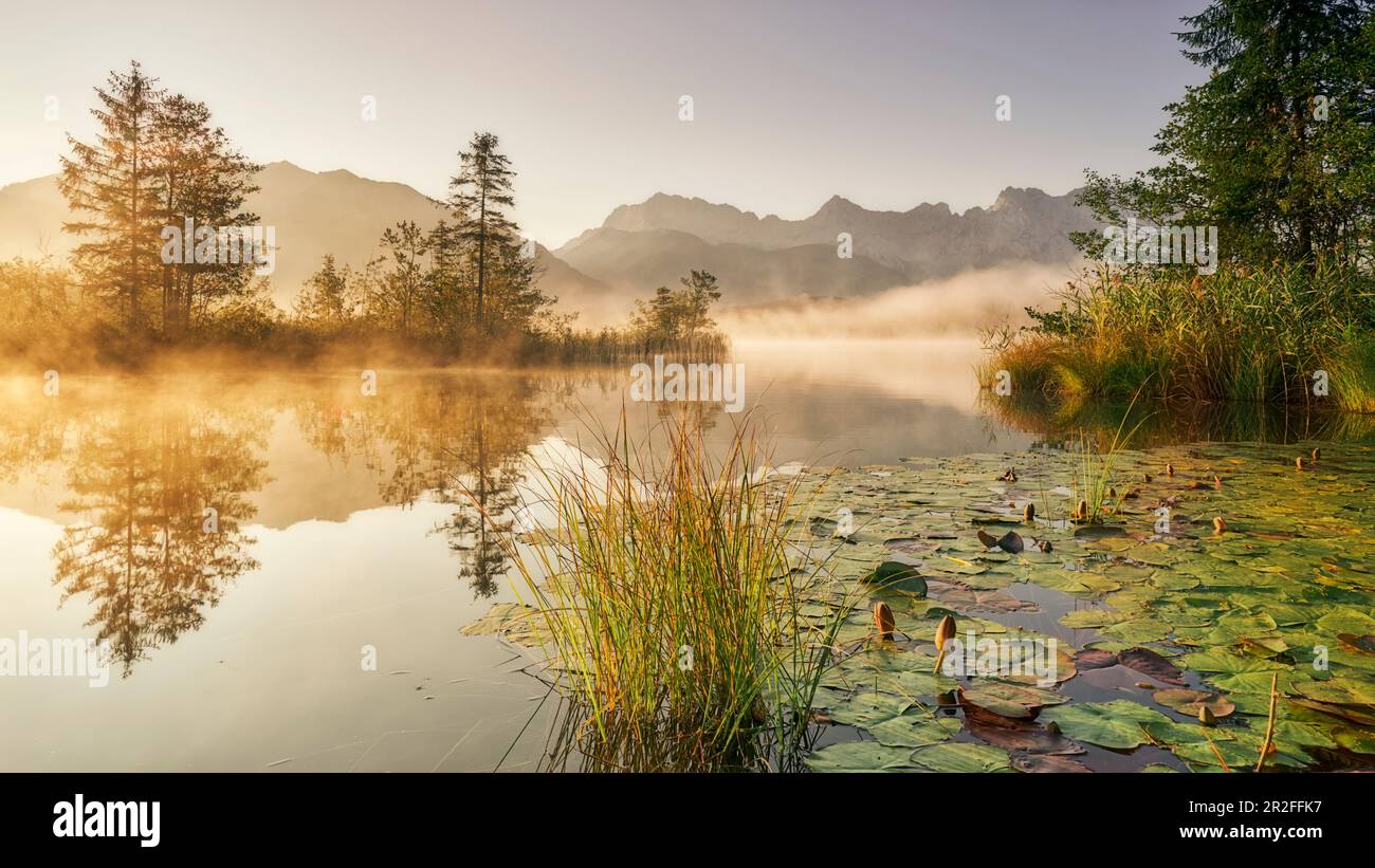 Sunrise at the Barmsee with a view towards the Karwendel massif ...