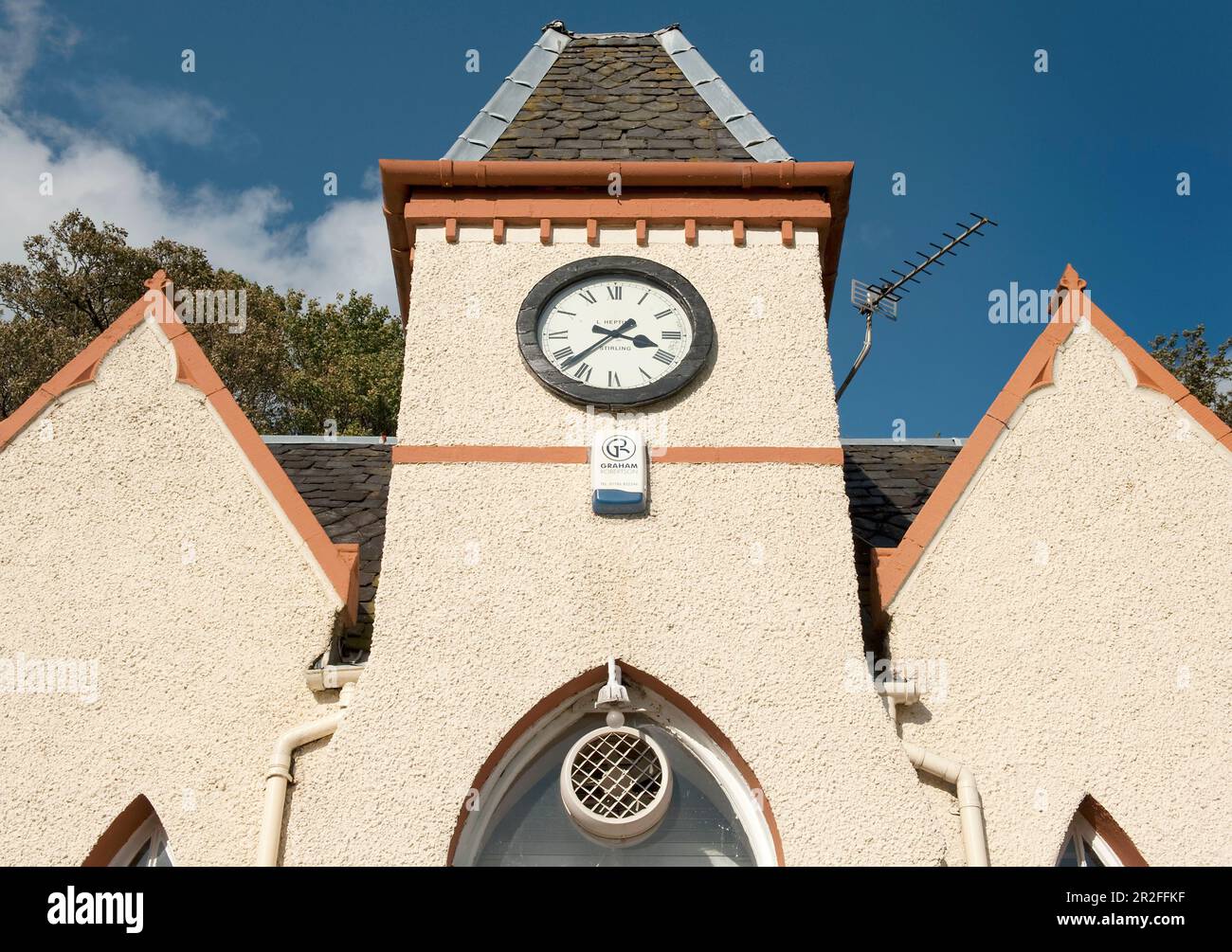 The clock on the front of the white pavilion club house at the Stirling lawn bowling club green in Stirling, Scotland, UK Stock Photo