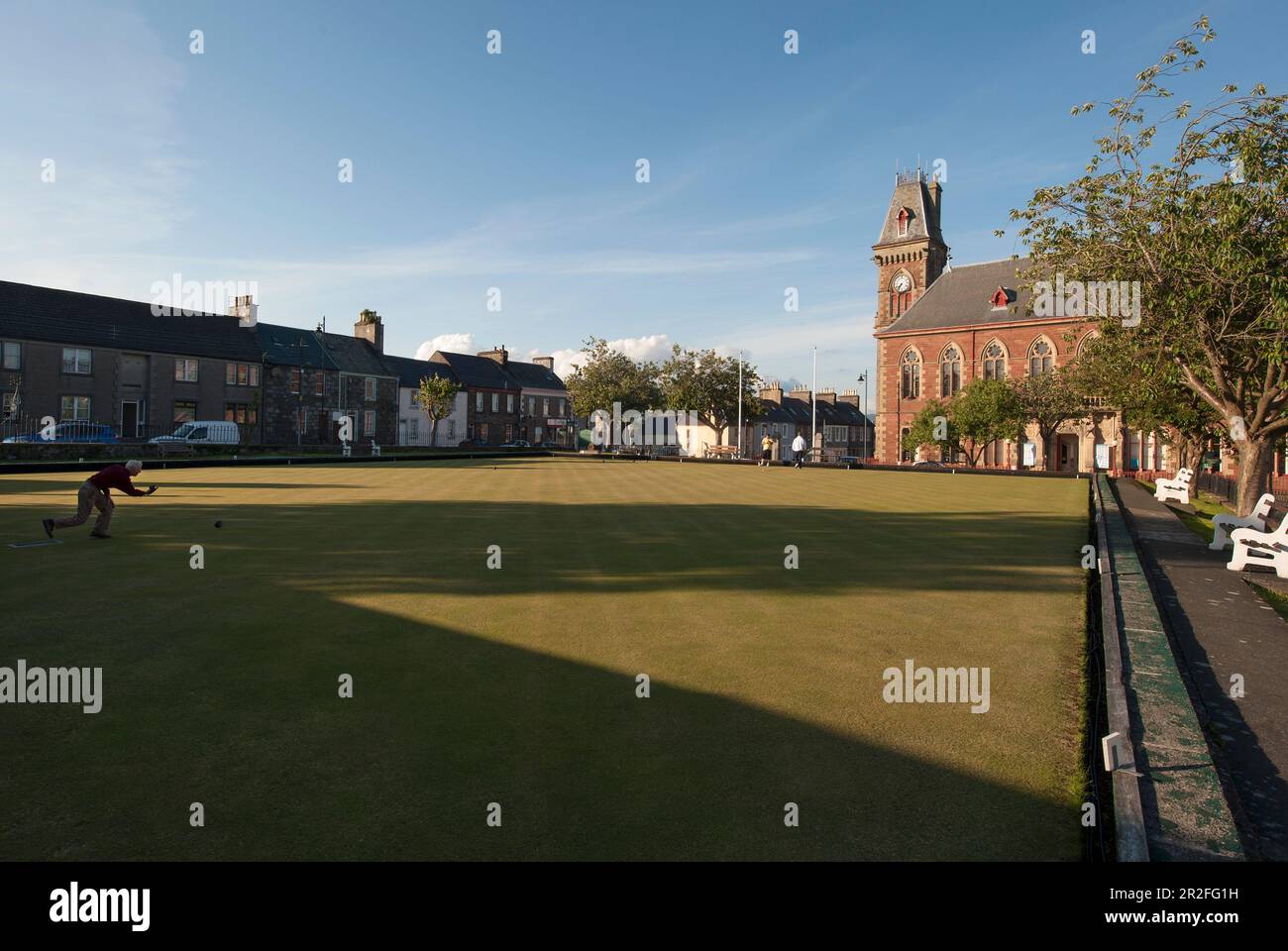 Bowls in play in front of the Wigtown County Buildings and Town Hall at the Wigtown lawn bowling club green in Wigtown; Dumfries; and Galloway, Scotla Stock Photo