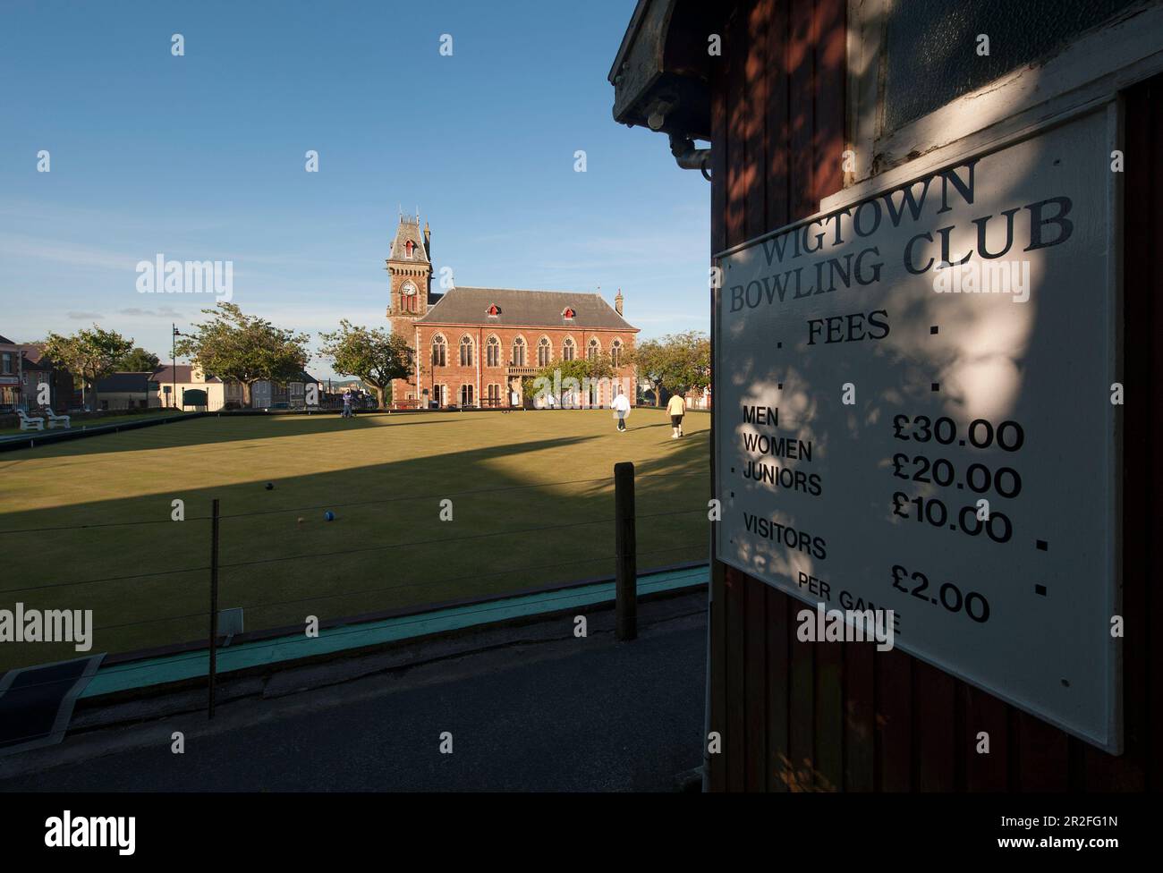 A sign outlining fees for the Wigtown lawn bowling club green in front of the Wigtown County Buildings and Town Hall in Wigtown; Dumfries; and Gallowa Stock Photo