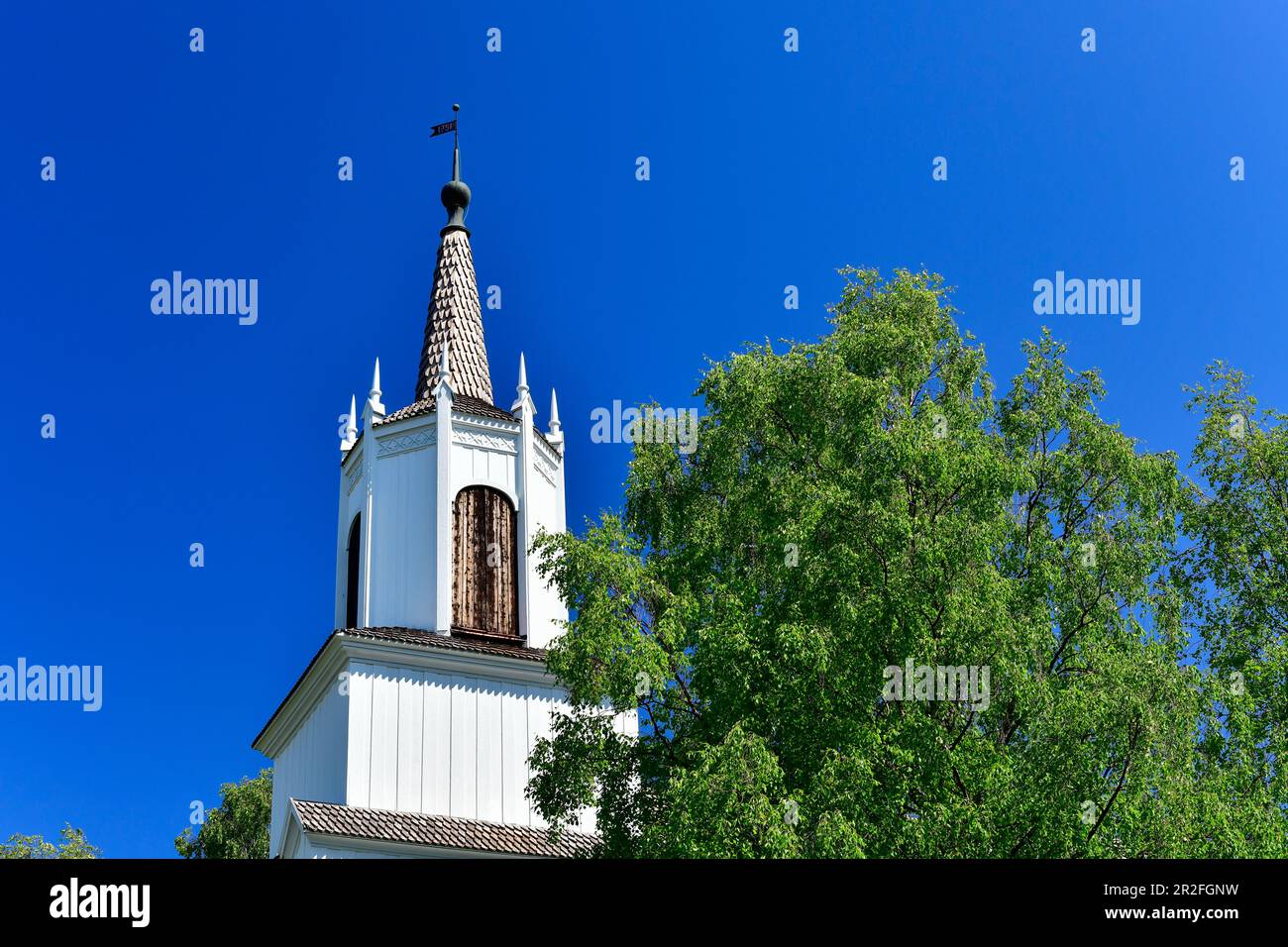 Wooden church and birch against a blue sky, Arvidsjaur, Norrbottens Län, Sweden Stock Photo