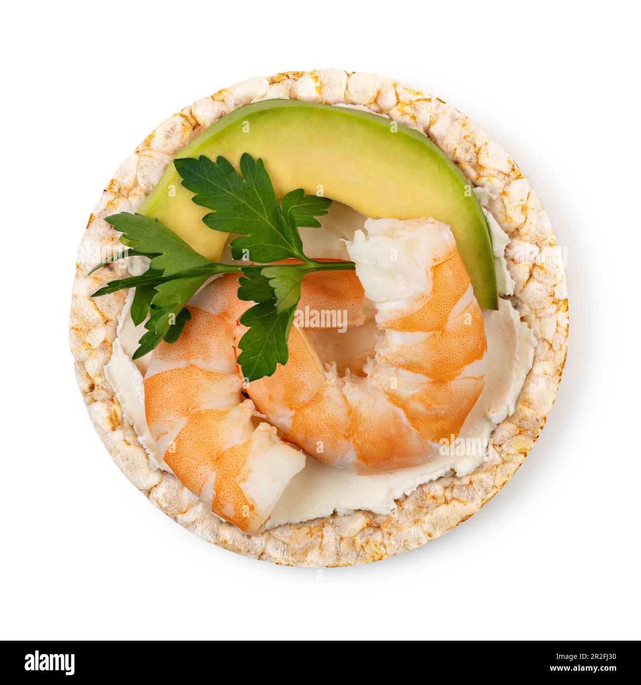 Rice cakes with cream cheese, shrimp, avocado and parsley top view