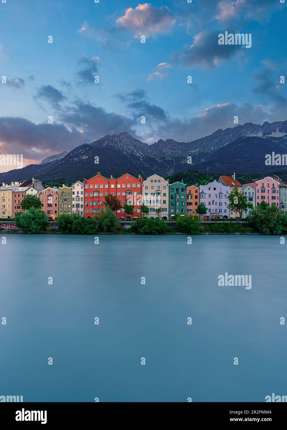 View over the Inn to the facades of Mariahilf and Sankt Nikolaus houses with the Nordkette in the background in Innsbruck, Tyrol, Austria Stock Photo