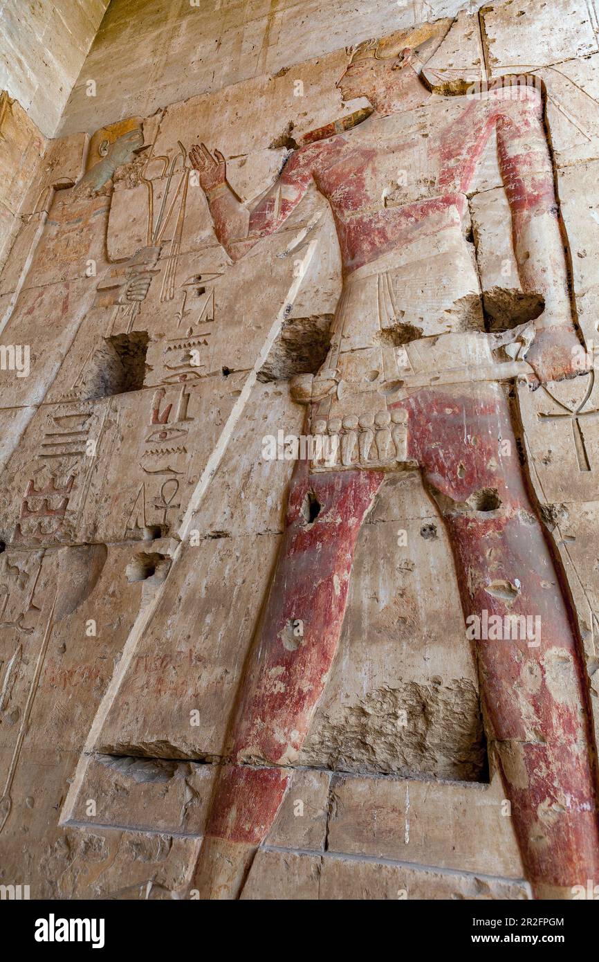 King Seti I receiving the royal flail and crook from the god Osiris in the Great Temple of Abydos, Egypt Stock Photo