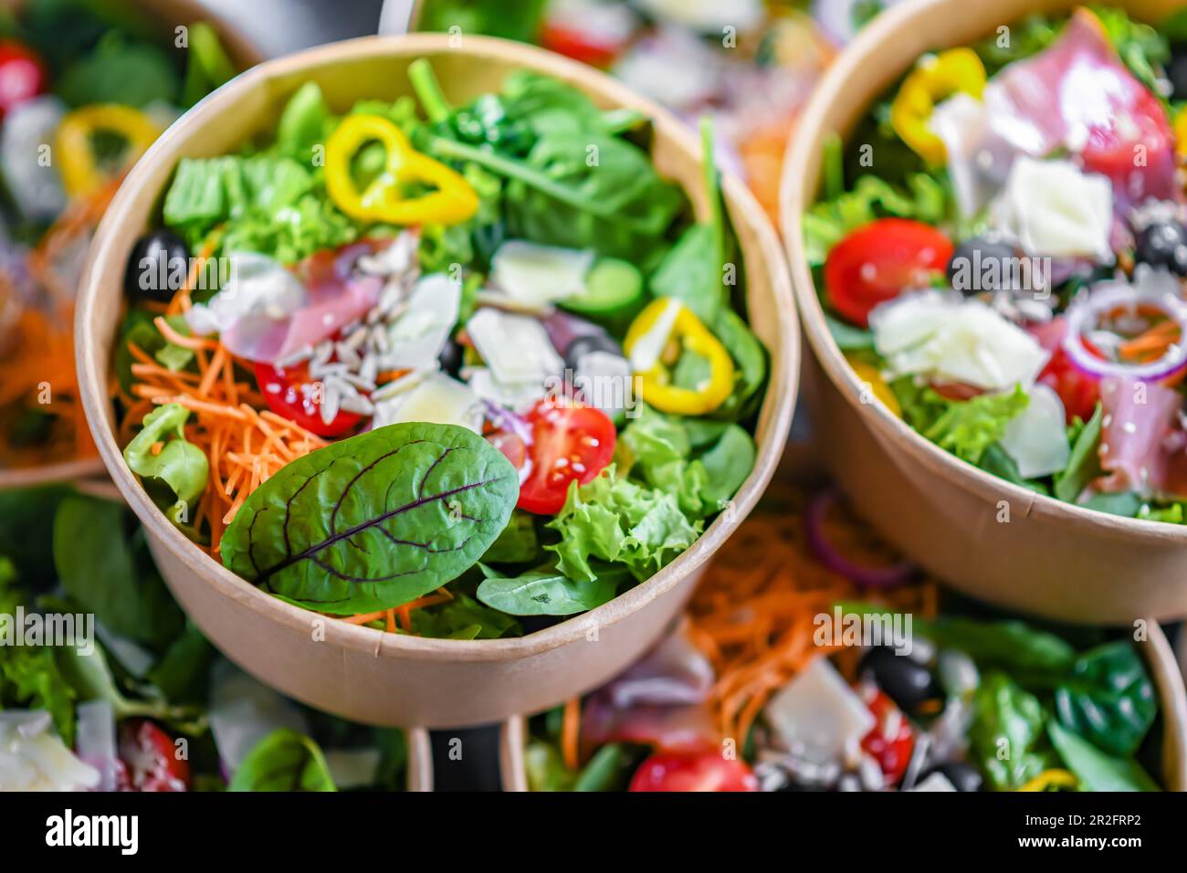 Round paper boxes with prepackaged vegetable salads ready for sale