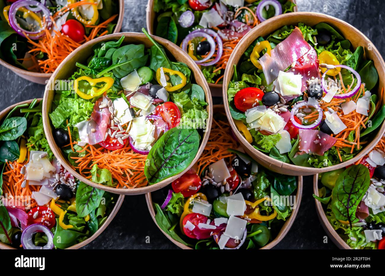 Round paper boxes with prepackaged vegetable salads ready for sale