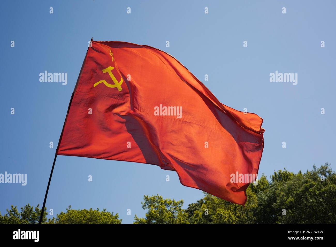 Russian national flag with hammer and sickle waving in the wind, Berlin, Germany Stock Photo