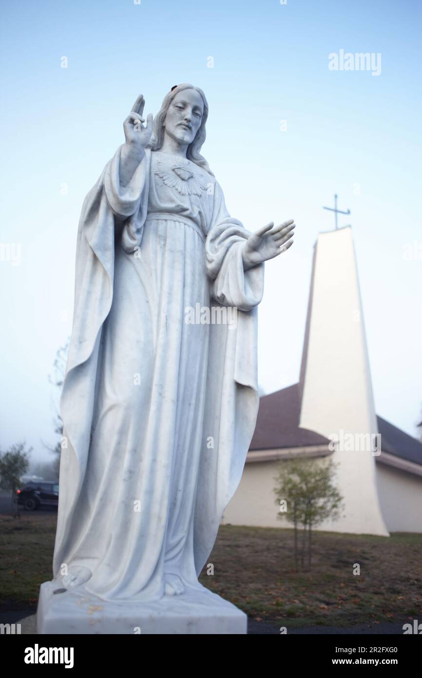 Statue of Jesus with church in the morning light at Point Reyes
