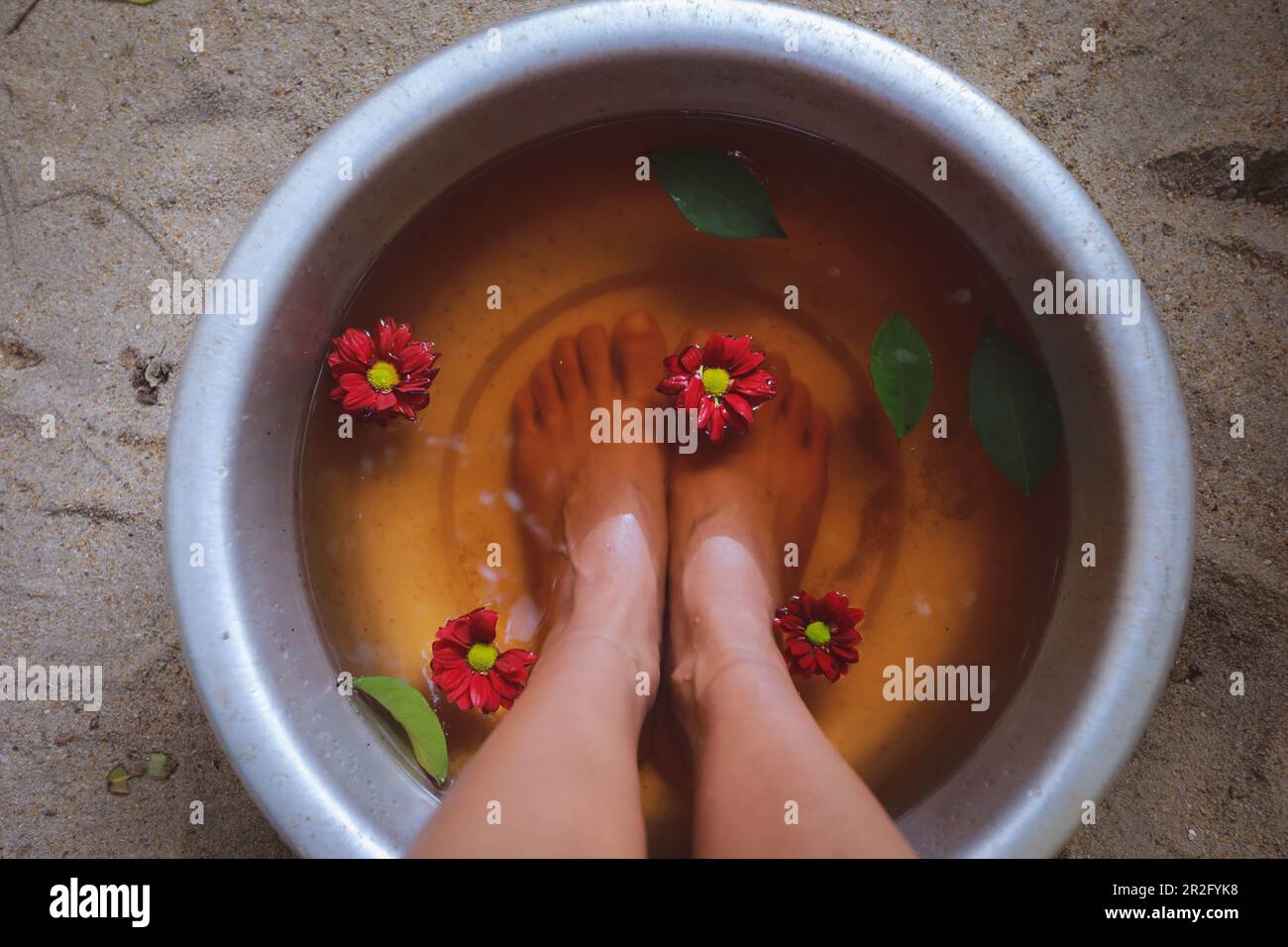 Feet in water, treatment, relaxing at spa, wellbeing concept Stock Photo