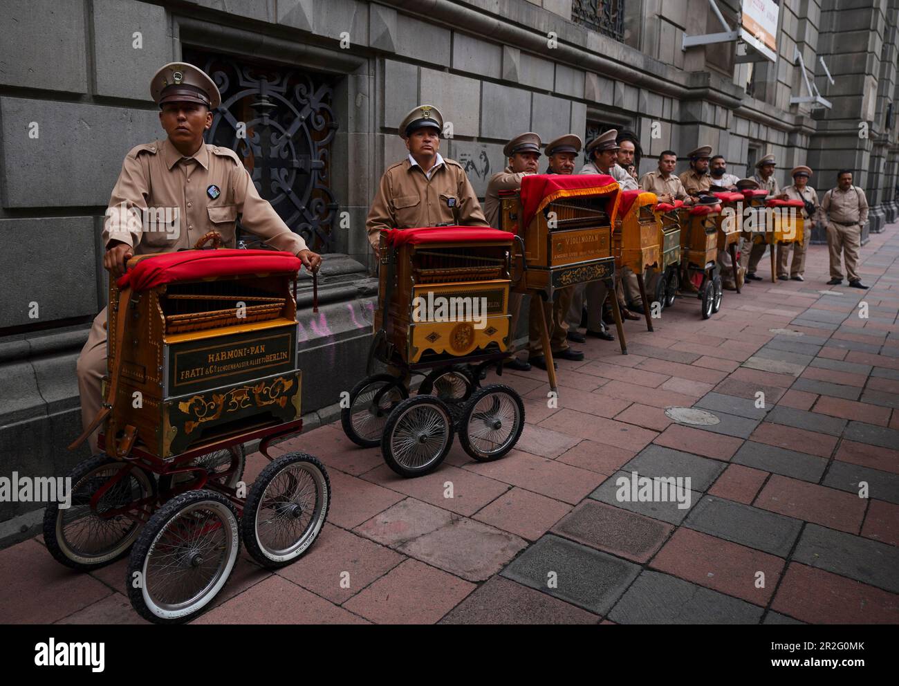 Organ grinders stand with their organs during the inauguration of the