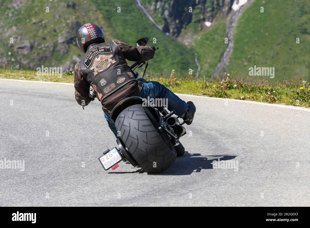 Motorbike with wide tyres, on the road on the winding Nufenen Pass in the Alps, popular motorbike route, Ulrichen, Obergoms, Canton Valais Stock Photo