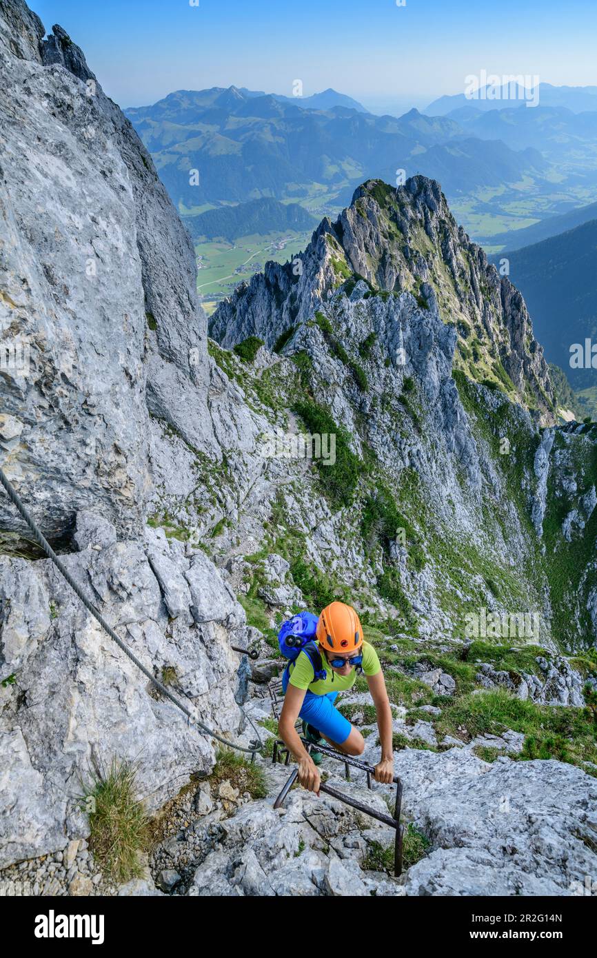 Woman mountaineering climbs via ferrata to Pyramidenspitze ...