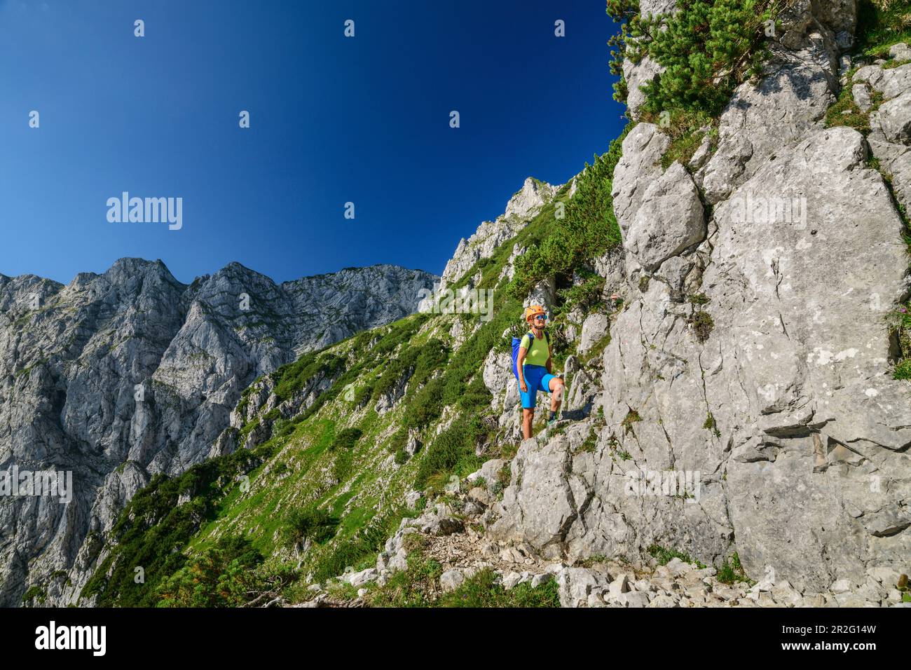 Woman mountaineering climbs via ferrata to Pyramidenspitze ...