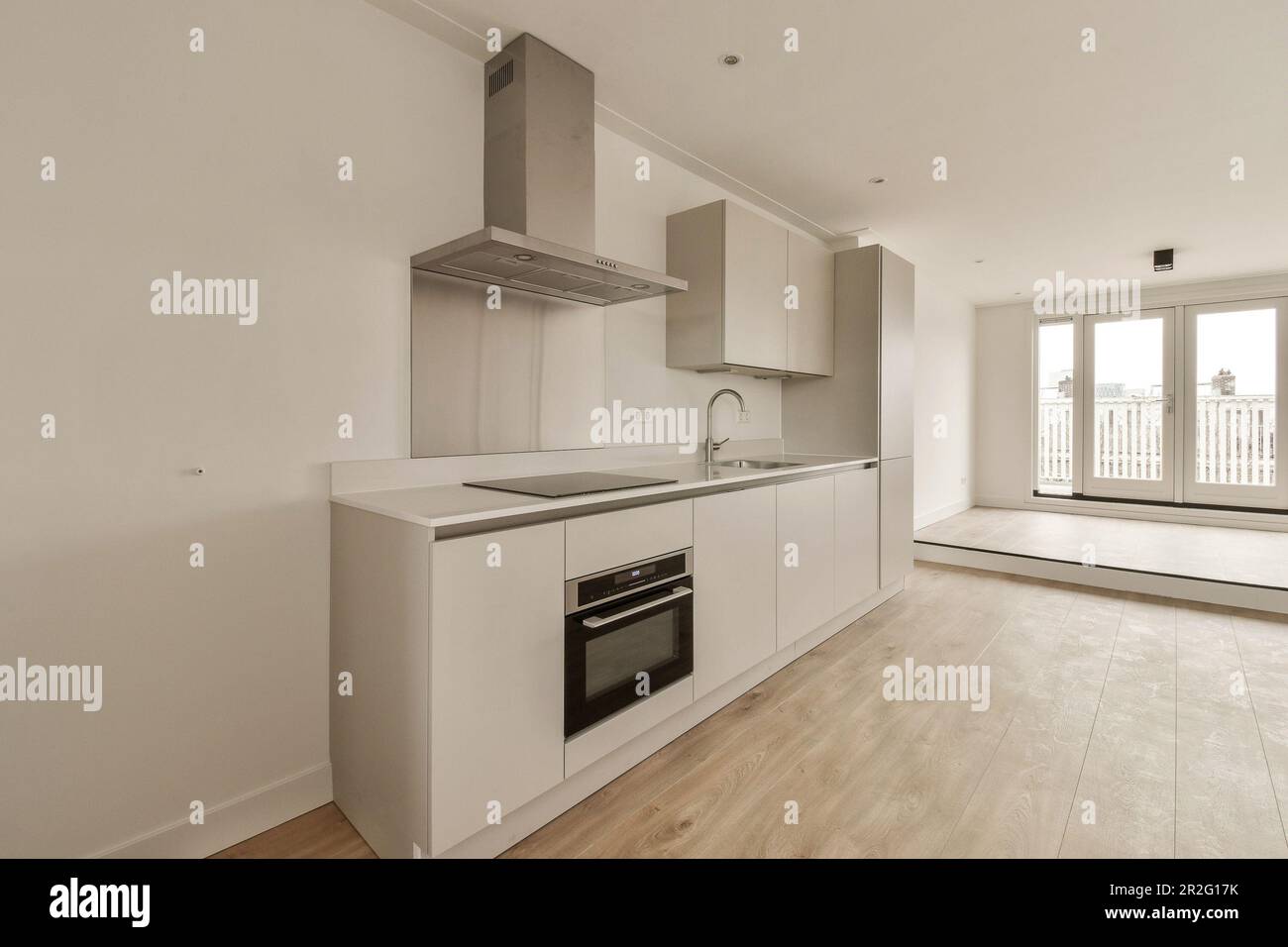 an empty kitchen with white cabinets and stainless appliances on the ...